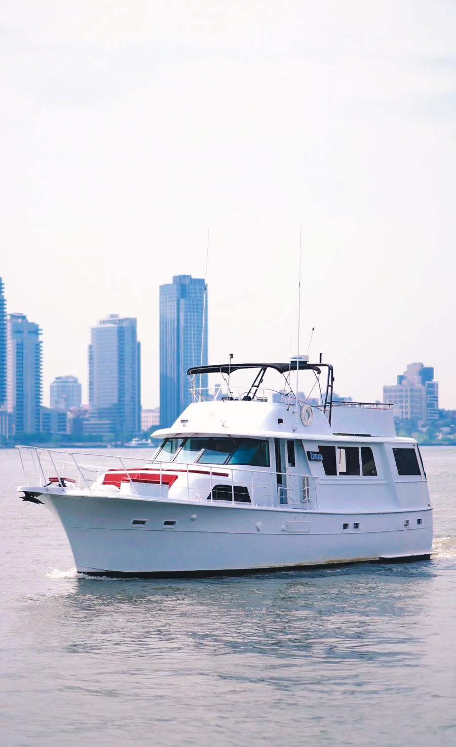 Pangaea, a Harbor Social charter yacht, underway on the Hudson River with the New York skyline behind it